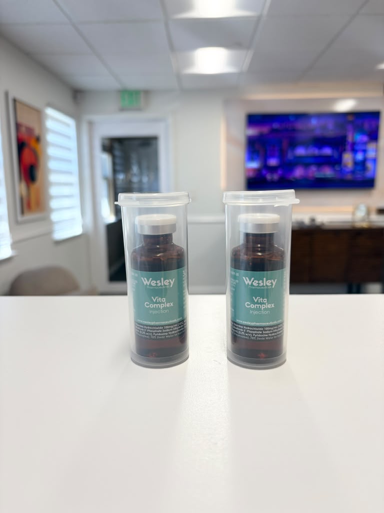 Two vials of Vita Complex vitamin injection on the GloVive front desk
